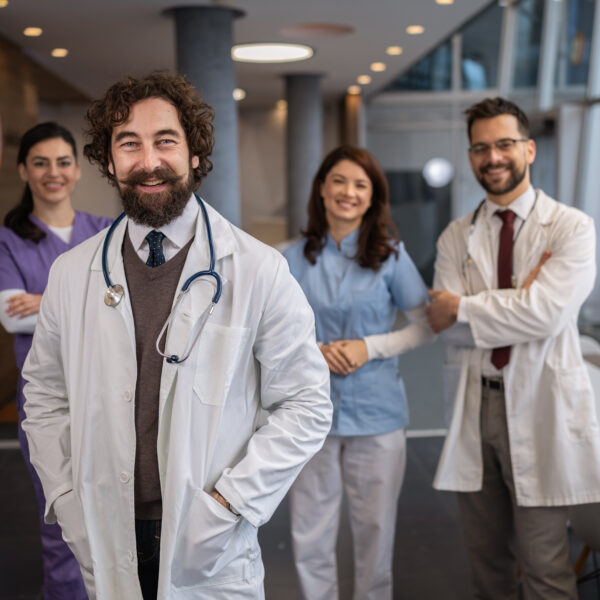 Medical team smiling in a hospital corridor.