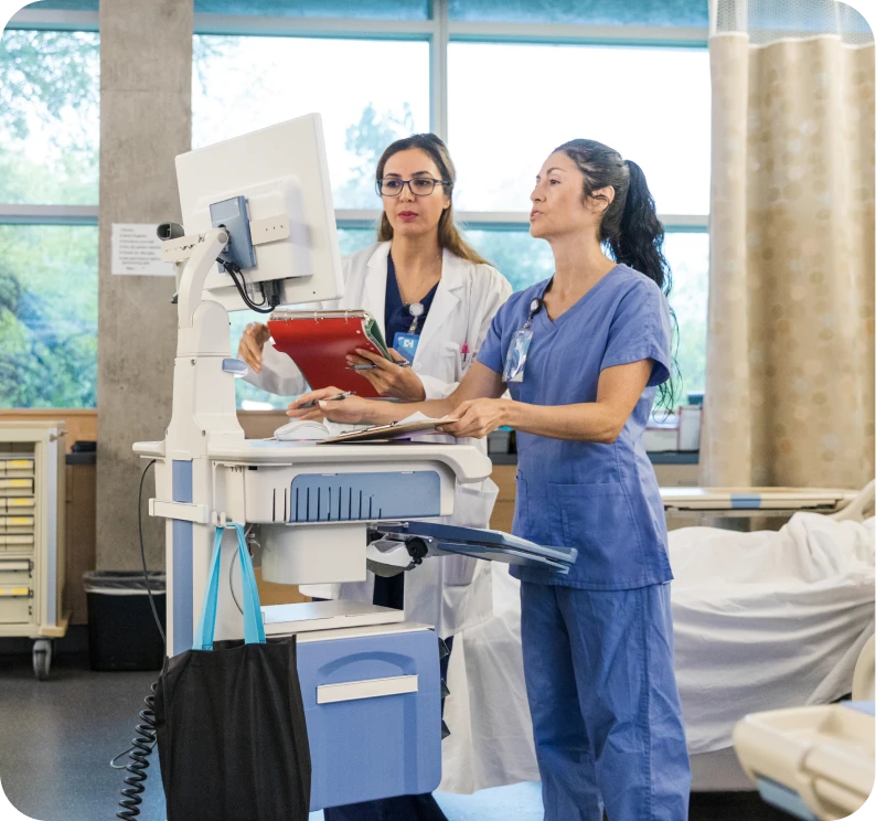 Two healthcare professionals reviewing patient information.