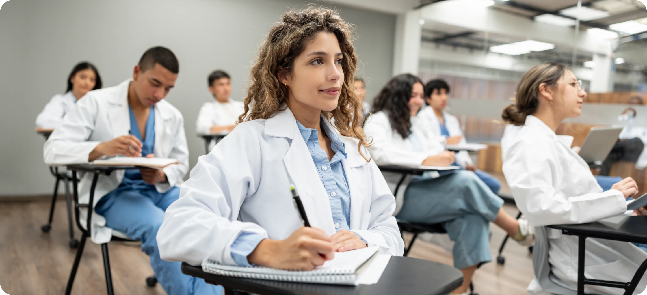 Medical students attentively listening in class.