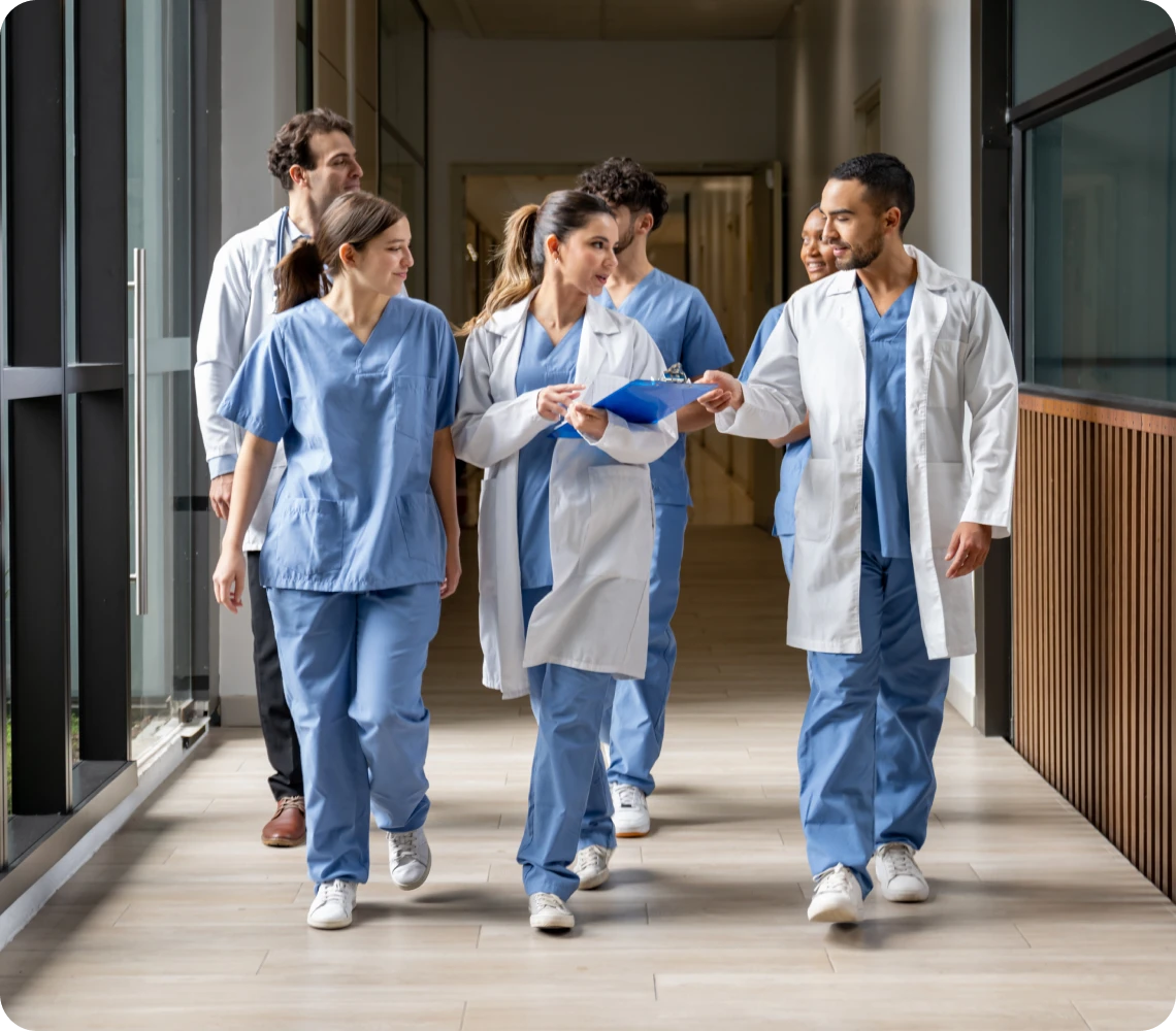 Medical team walking in hospital corridor.