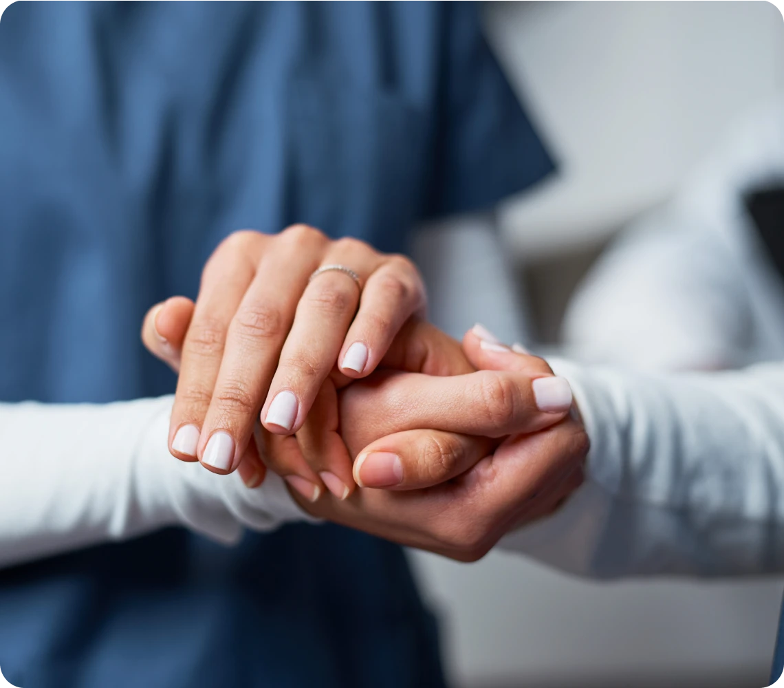 Hands holding each other, offering support.