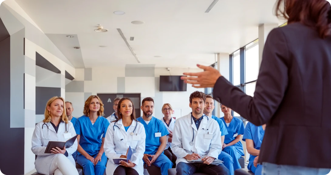 Medical professionals attending a seminar presentation.